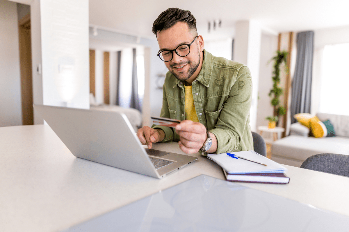 A man subscribing to a product holding a credit card